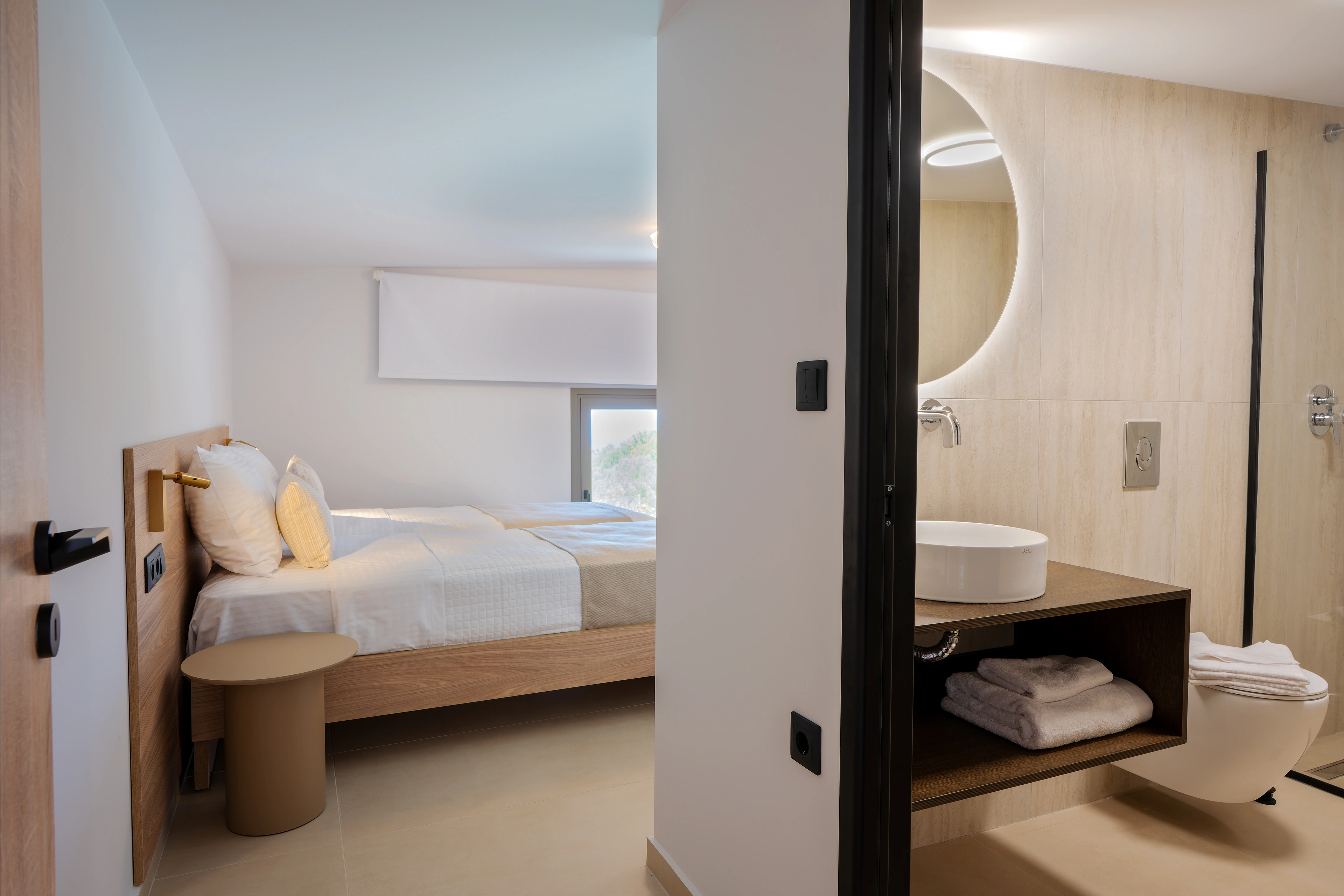 Right Crete bedroom 04 with two single beds and the private bathroom visible beside the sleeping area