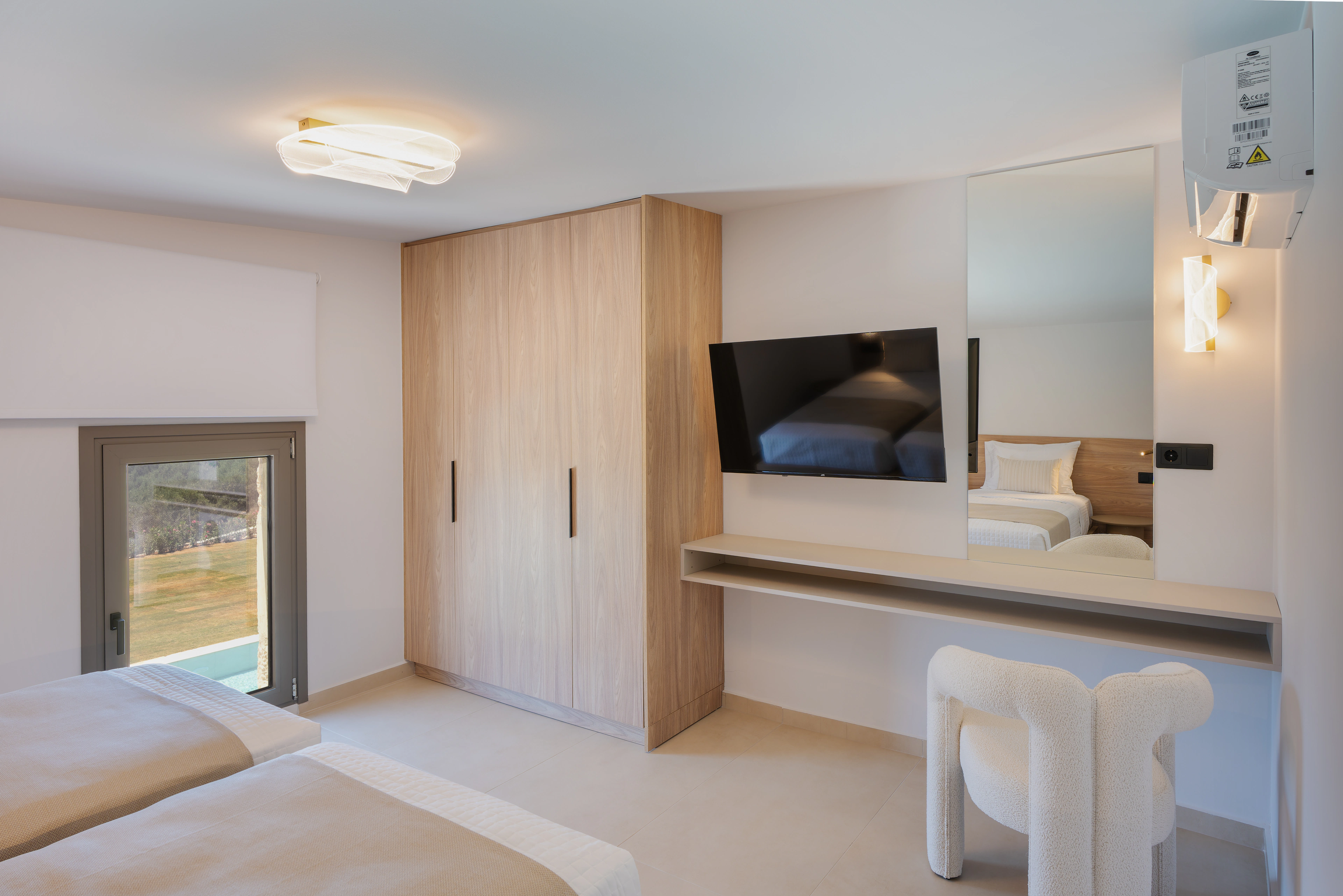 Right Crete bedroom 04 with two single beds, television, timber wardrobe and garden doorway