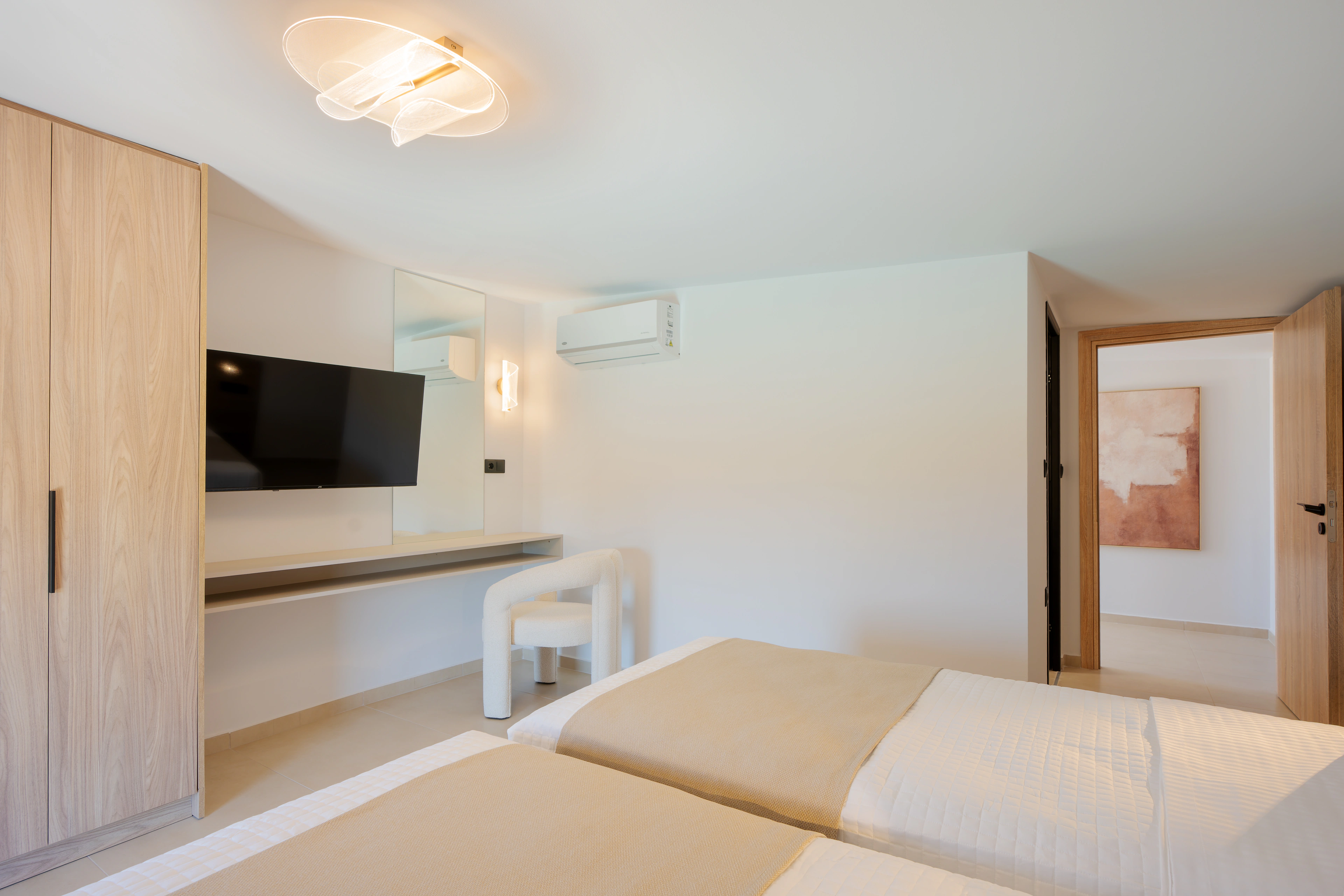 Wide view across the two single beds and dressing area in Right Crete bedroom 04