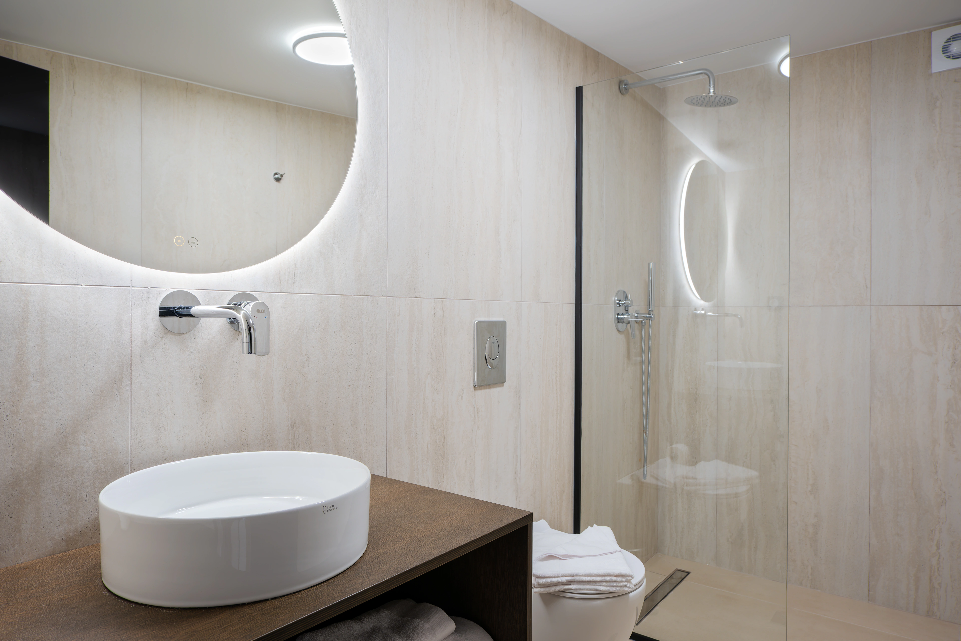 Private en-suite bathroom for Right Crete bedroom 04 with pale stone shower and vanity