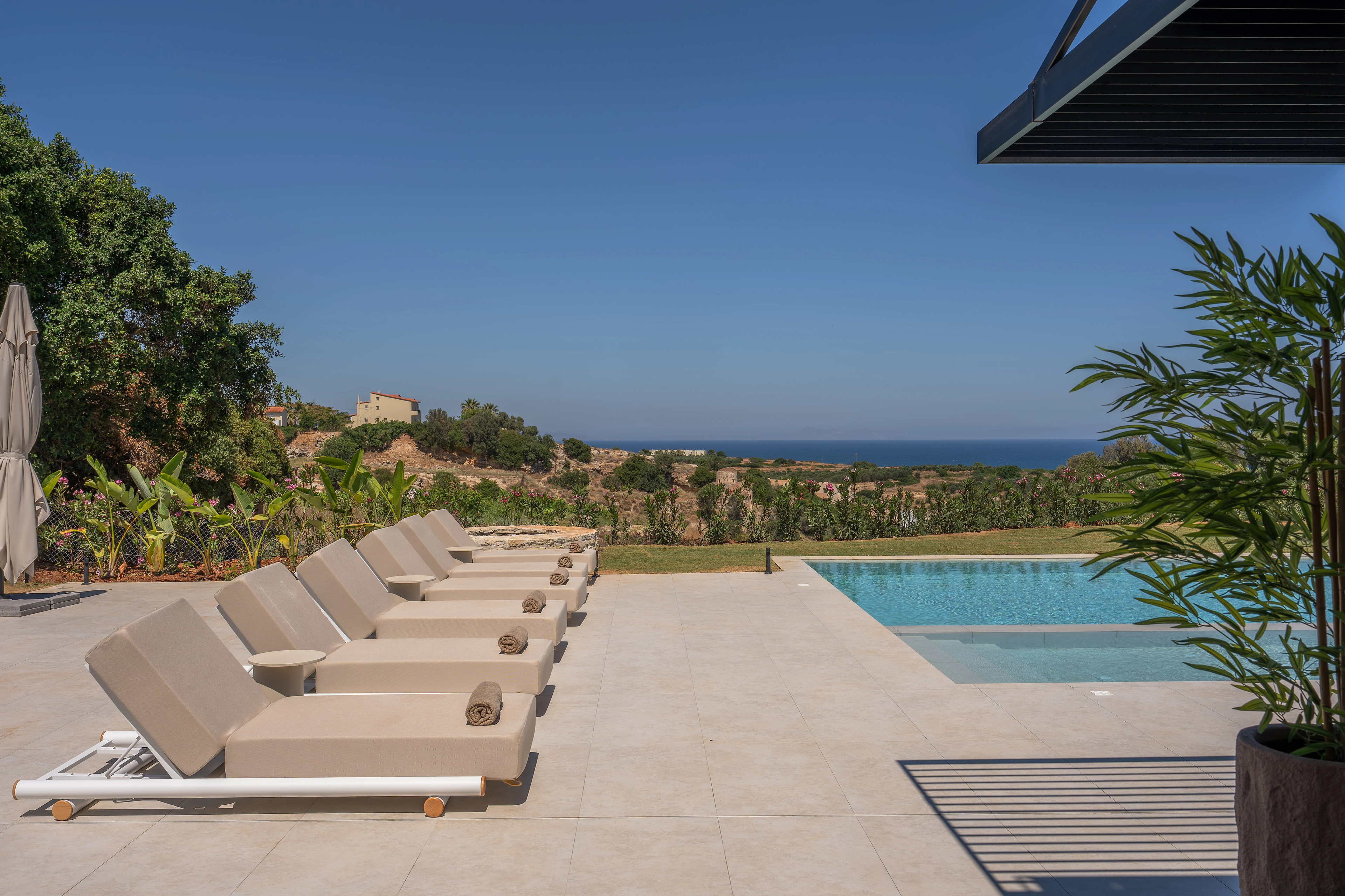 Left Crete loungers and private pool opening toward the Cretan Sea