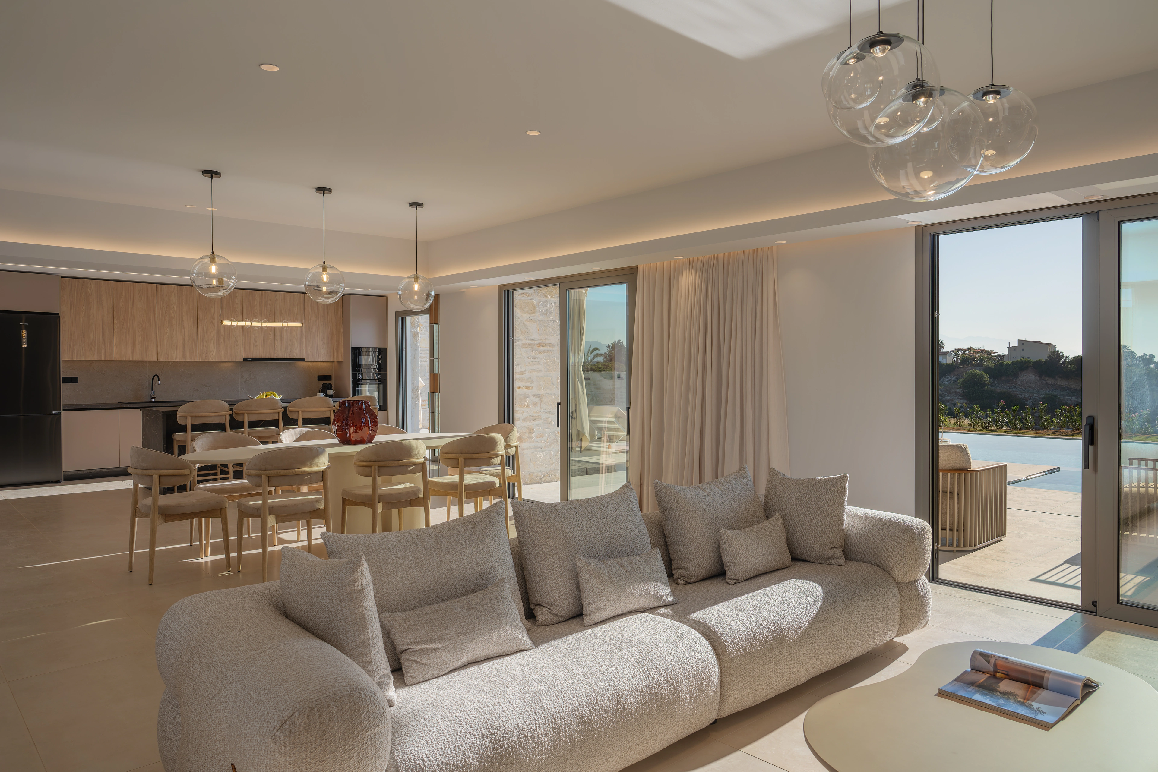Right Crete's living room with wide doors opening to the pool