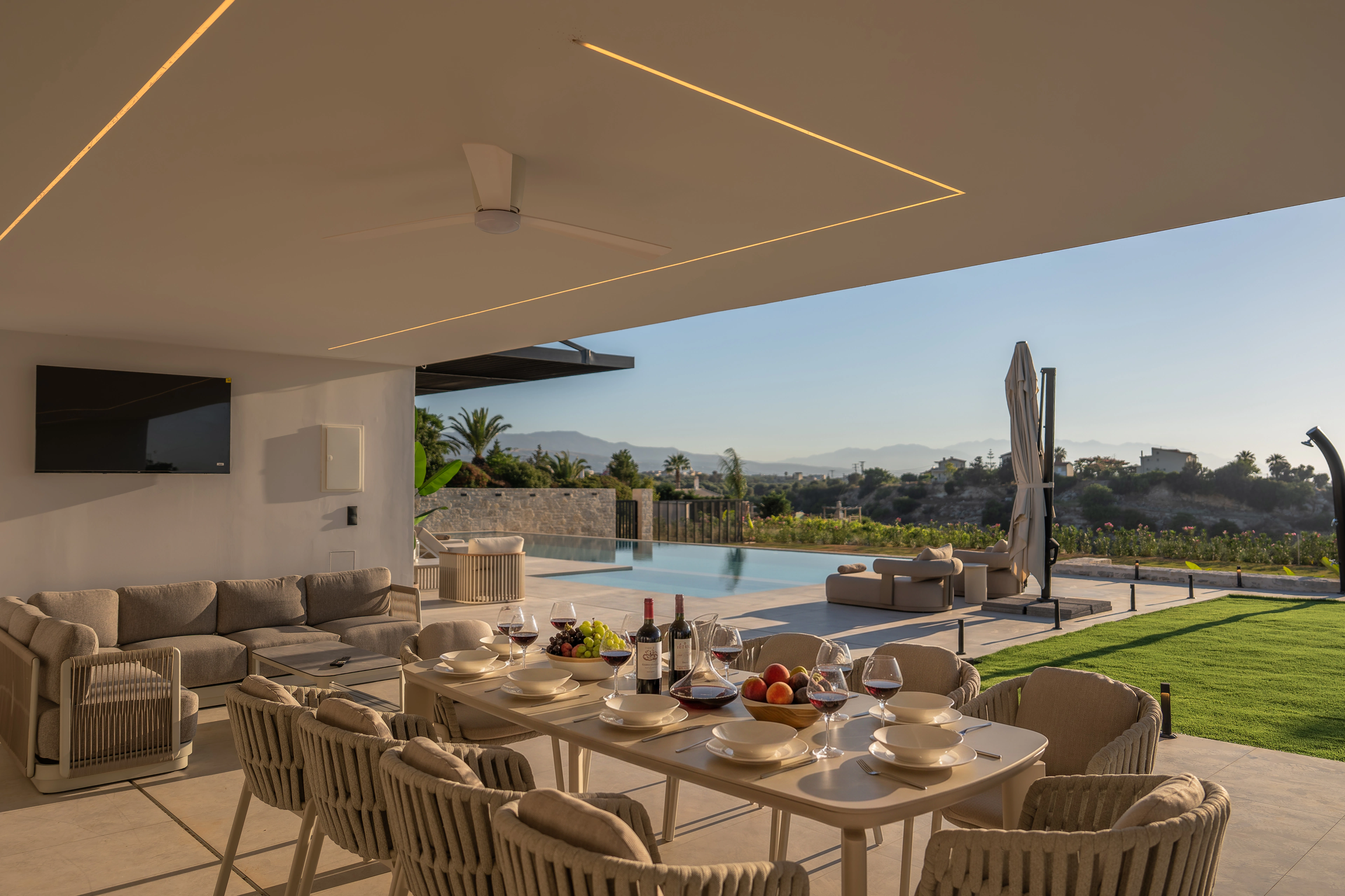 Right Crete's outdoor dining table prepared beside the pool and garden