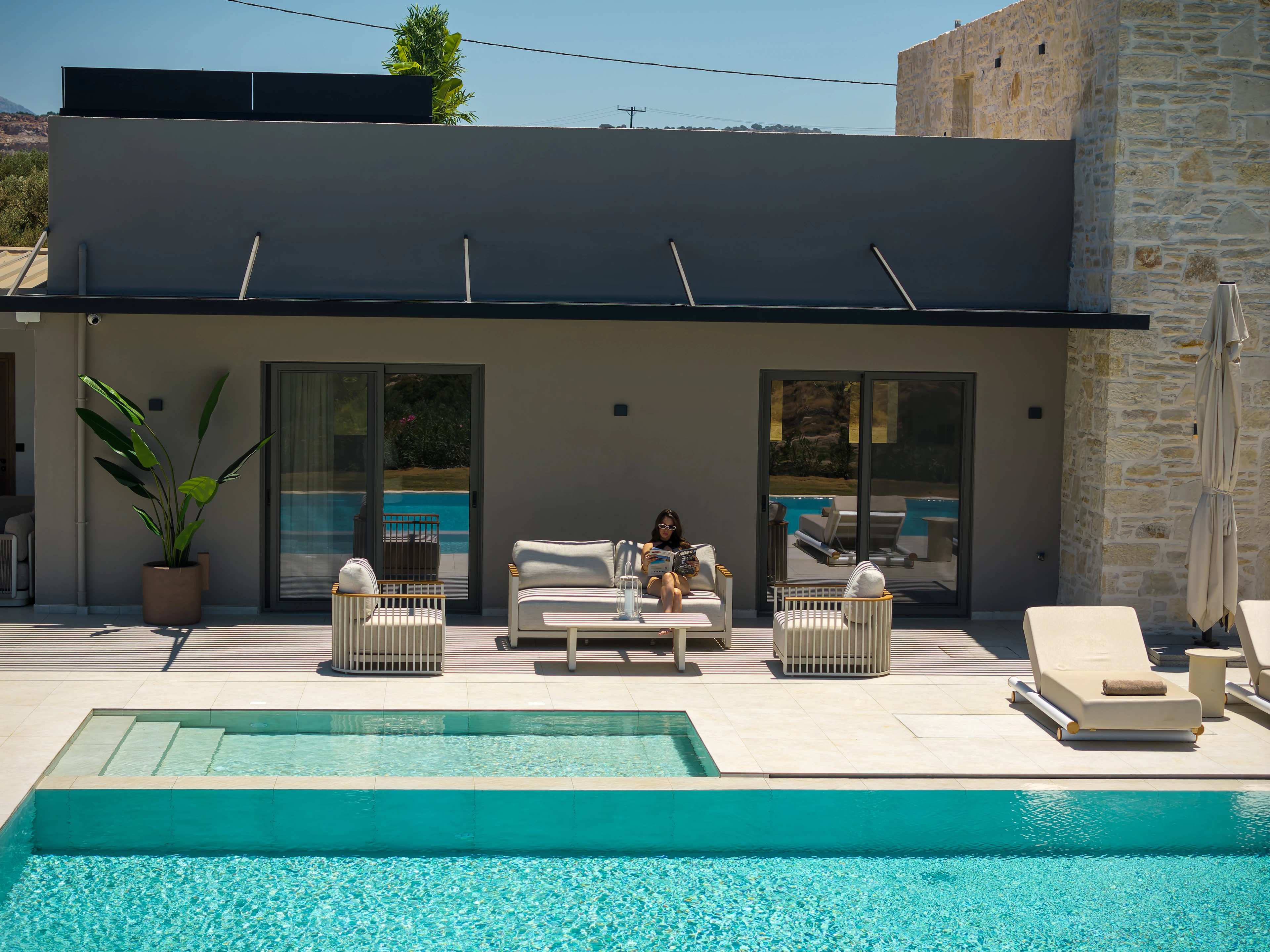 A guest in Right Crete's outdoor lounge beside the pool