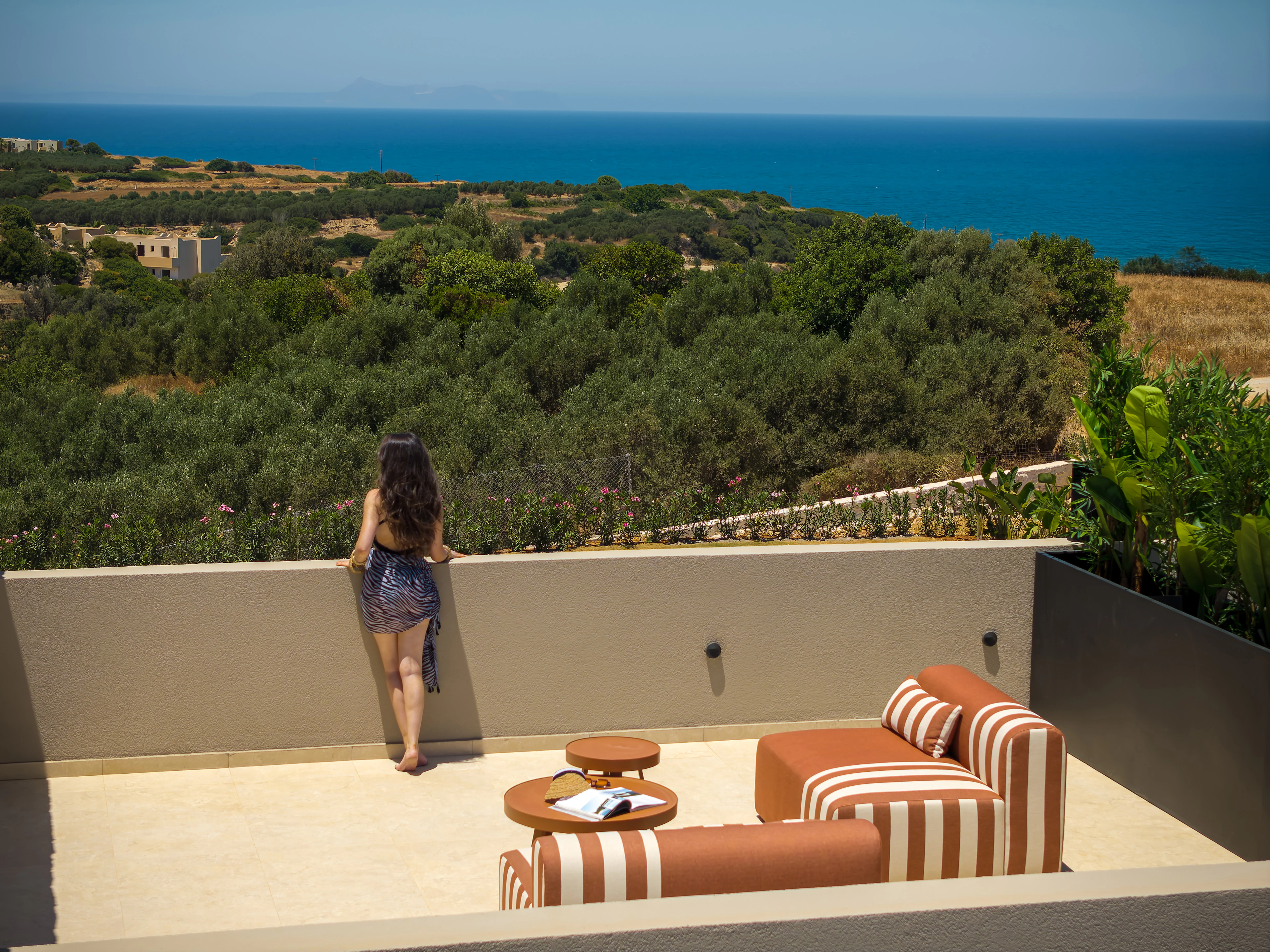 A guest looking toward the Cretan Sea from Right Crete's private upper veranda