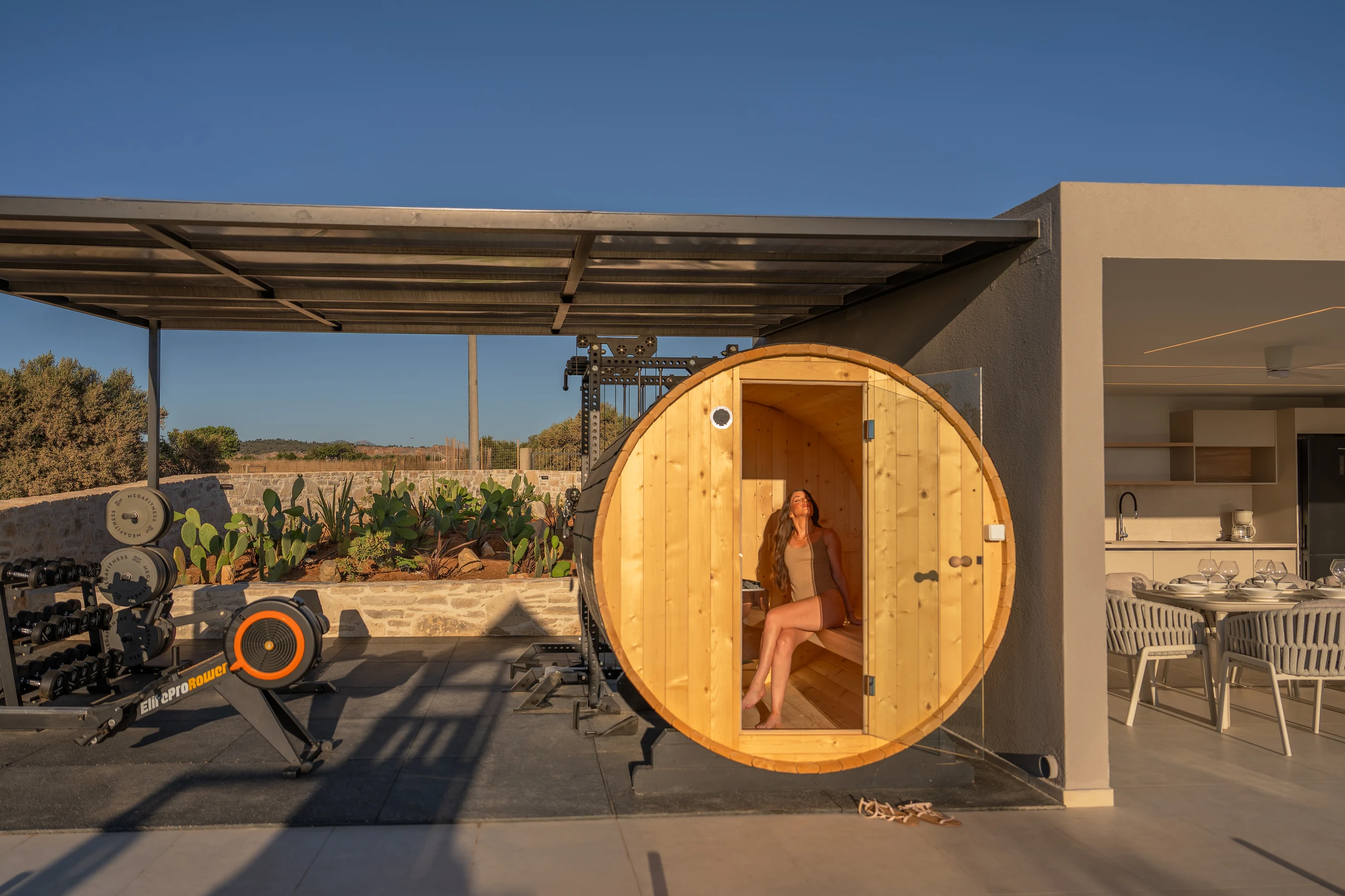 Right Crete's private timber barrel sauna beside the outdoor kitchen and gym